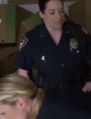 A police officer assisting during an arrest, maintaining order with professionalism